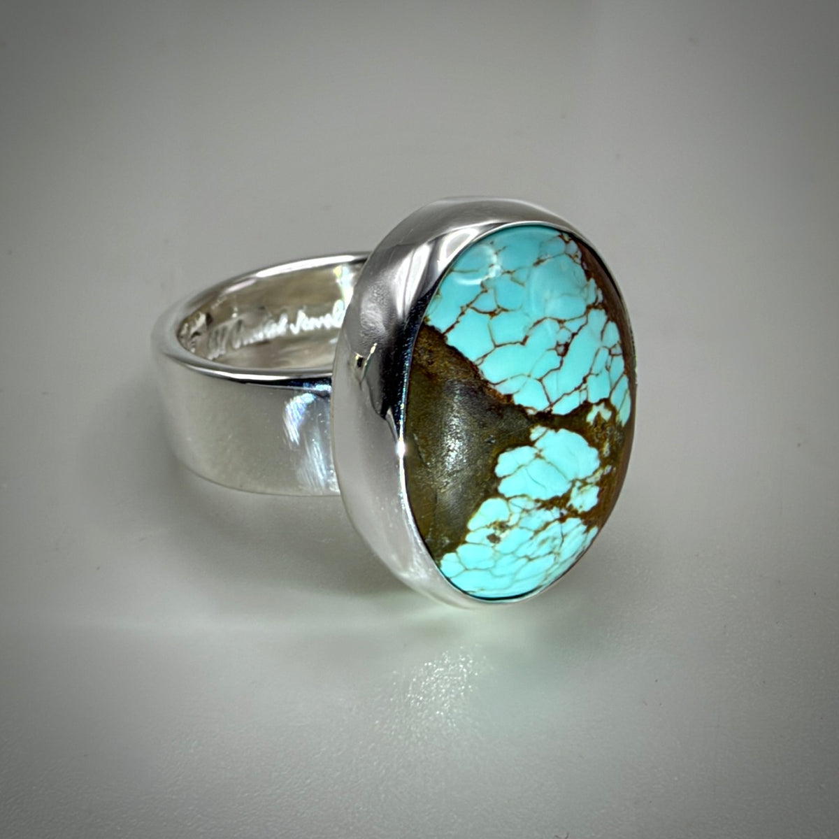 Blue oval turquoise ring shiny silver with gray background