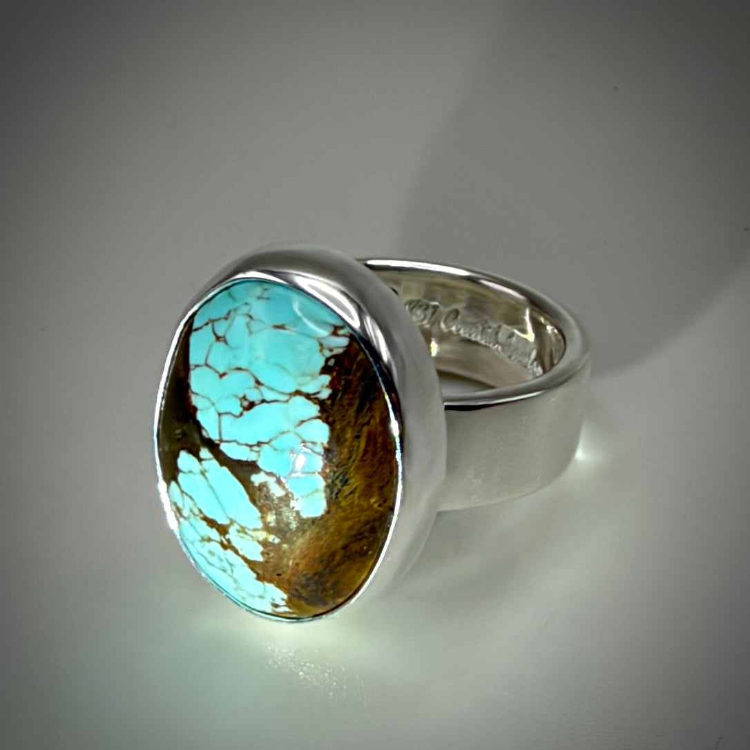 Blue oval turquoise ring shiny silver with gray background 
